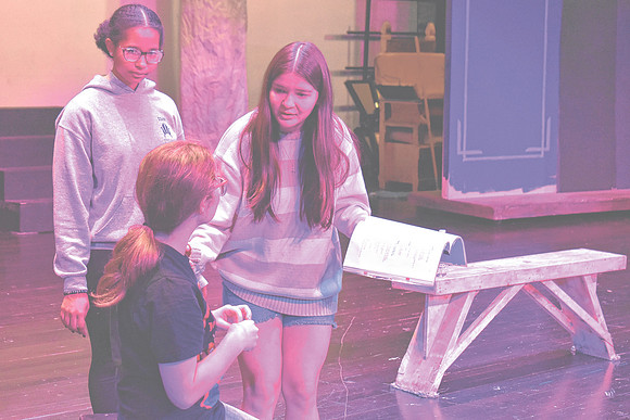 Nicky Sergi, who is portraying Alice in Greenwood's production of "Alice in Wonderland," rehearses with two other cast members, Wednesday, Oct. 23, 2024, at Greenwood Community High School in Greenwoo