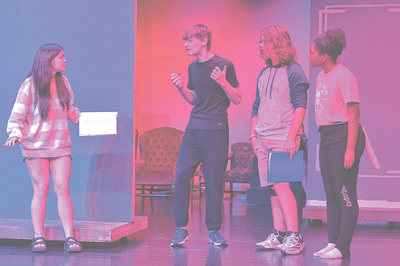 From left, Nicky Sergi as "Alice," Adam Soboleski as "The March Hare," Jonathan Chelf as "The Mad Hatter," and Ruby Martin as "The Dormouse" rehearse a scene from "Alice in Wonderland," Wednesday, Oct
