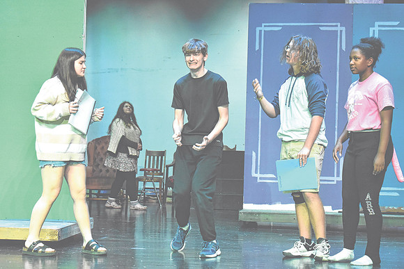 Adam Soboleski as "The March Hare," center, exclaims during a rehearsal for "Alice in Wonderland" with co-stars Nicky Sergi as "Alice," Jonathan Chelf as "The Mad Hatter," and Ruby Martin as "The Dorm